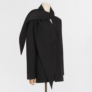Detail of black wool blazer featuring a unique integrated scarf collar and single button