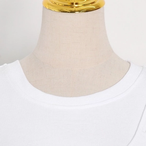 Close-up of white ribbed knit long sleeve shirt showing detail of the round neckline