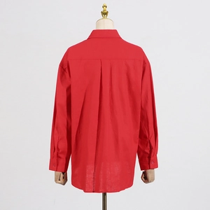 Detail view of red long-sleeve shirt with inverted box pleat design on the back