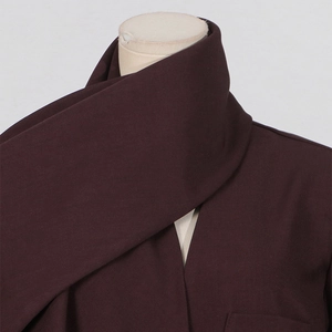 Detail of premium burgundy woven fabric showing thick texture and elegant neck drape