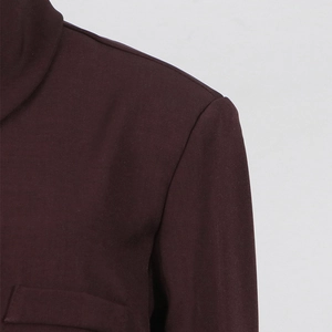 Detail of shoulder tailoring and pocket flap on deep brown modern casual blazer jacket