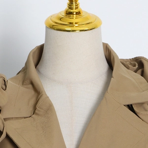 Detailed close-up of khaki trench coat collar with precise stitching on high-quality fabric