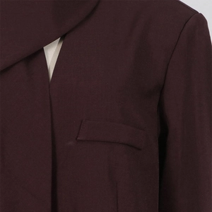Close-up detail of dark brown twill fabric texture and lapel stitching on blazer
