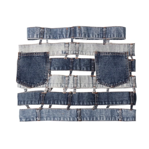 Close-up of deconstructed denim skirt featuring tiered waistband and raw edge details