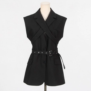 Detail view of sleeveless black blazer vest featuring cross-strap design and eyelet belt