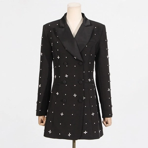 Detail of crystal flower patterns on a black blazer with satin lapel and rhinestones