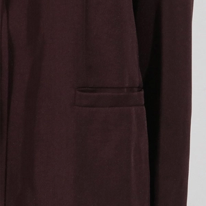 Detailed close-up of the single-breasted coffee brown blazer with a sleek welt pocket