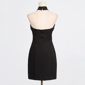 Detail of black halter dress showing criss-cross back straps and waist-cinching cut
