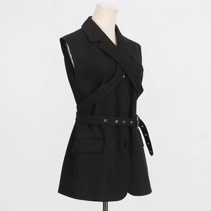 Detail of black sleeveless blazer featuring notched lapels and a belted waist with eyelets