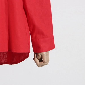Detailed macro view of red cotton linen shirt cuff and curved hem with precise stitching