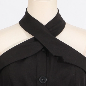 Detail of cross halter neckline with buttons on black slim fit summer dress