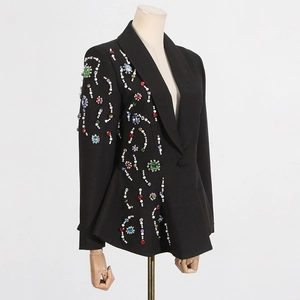 Detailed view of luxury rhinestone and pearl embroidery on a black slim fit blazer