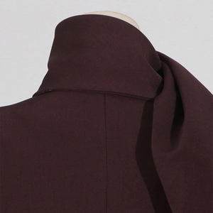 Detailed close-up of dark coffee blazer neckline with thick twill fabric texture