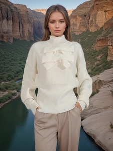 Elegant cream knit sweater featuring double layered bows and mock neck design