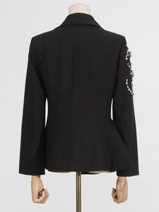 Women's black tailored blazer with crystal and pearl embellishments on the sleeve back view