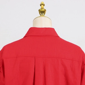 Detail of red linen shirt collar and back pleat design for a relaxed casual fit