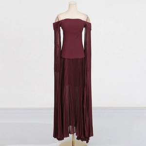 Close-up of burgundy off-shoulder evening dress with long draping sleeves and pleated skirt