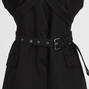 Detail of black blazer waist with matching belt and silver square metal buckle