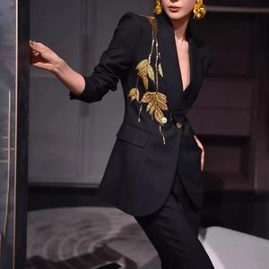 Detail showing elegant gold leaf embroidery on the black blazer lapel with sequins