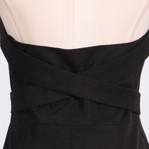 Detail of the crisscross lace-up back design on a minimalist black summer dress