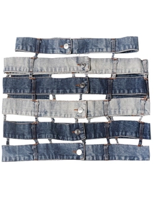 Patchwork denim mini skirt featuring layered multi-wash belts and silver metal buttons