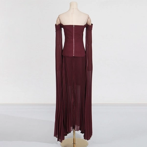 Detail view of burgundy off-shoulder top with silver back zipper and pleated maxi skirt