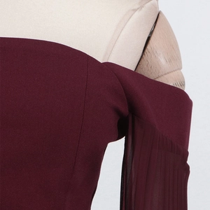 Detail of off-shoulder neckline and pleated sleeves on wine red elegant dress
