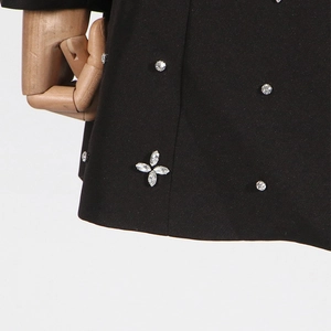 Detail of rhinestone floral pattern and sewing texture on black slim fit blazer jacket
