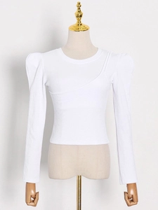 Slim fit white ribbed long sleeve top featuring dramatic puff sleeves and asymmetrical seams