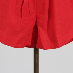 Close-up of red linen-blend shorts detailing double stitching and drawstring waistband