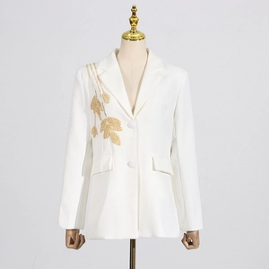 Detail of elegant ivory blazer with golden leaf embroidery and classic notch lapel