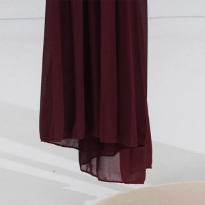 Detailed view of dark burgundy pleated chiffon skirt hem with delicate layered stitching