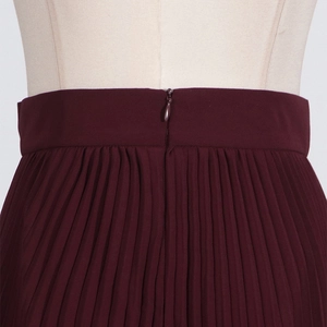 Detailed view of burgundy pleated skirt waist featuring a seamless invisible zipper closure