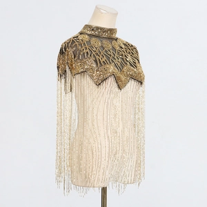 Detail of elegant gold beaded collar capelet with intricate sequins and long fringes