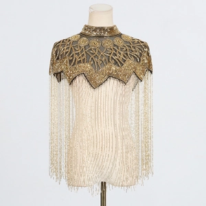 Detailed view of luxury gold beaded shoulder epaulette with long dangling fringe accents