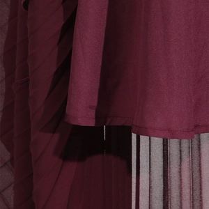 Detailed view of burgundy off-shoulder dress featuring fine pleats and premium stitching