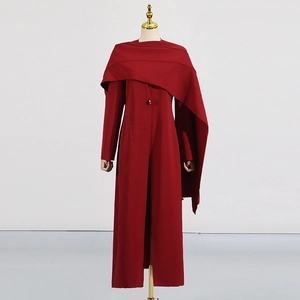 Détail d'un manteau long rouge avec col croisé asymétrique et fermeture à un seul bouton