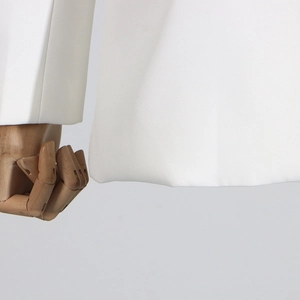 Detailed close-up of premium woven fabric and stitching on a white elegant blazer sleeve