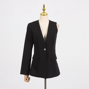 Detail of black asymmetric blazer featuring one long sleeve and one sleeveless side