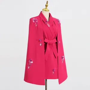 Detailed view of fuchsia cloak blazer featuring hand-sewn sequin floral shoulder accents