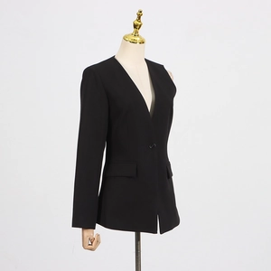 Detail of slim fit black blazer featuring a collarless V-neck and single button closure
