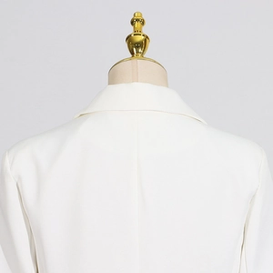 Close-up of the elegant back neckline and shoulder tailoring on the white blazer jacket