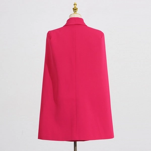 Rear view of hot pink cape blazer showing structured silhouette and elegant drape fabric