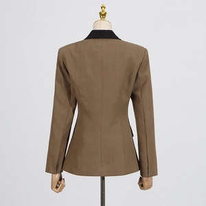 Detail of the tailored back of a women's khaki blazer with a stylish black contrast collar