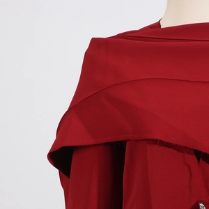 Détail d'un manteau rouge foncé avec bords francs et structure de col superposée