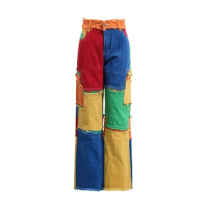 Detail of high waisted patchwork denim jeans with colorful panels and raw edge seams