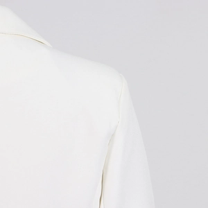 Detail of elegant white suit jacket showing high-quality stitching and fabric texture