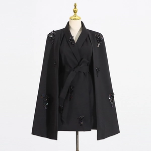 Close-up of elegant black cape blazer featuring intricate floral sequin and bead embroidery