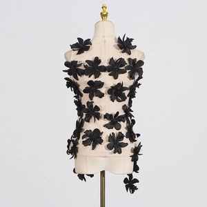 Detail of floral mesh vest featuring 3D black flowers and back zipper closure
