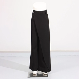 Detail of high-waist wide-leg trousers featuring a unique wrap crossover waist design
